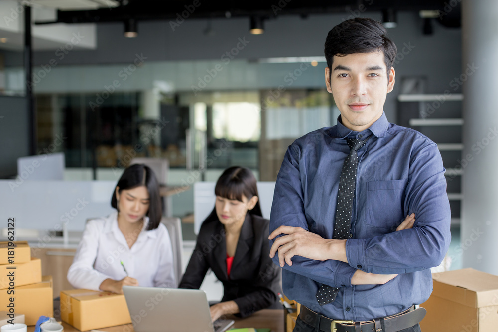 Young Asian Man standing with smiling at office, Young Owner Man Start up for Business Online, SME, Delivery Project, Businessman successful with Online Business or SME Concept. Young Asian Man standing with smiling at office, Young Owner Man Start up for Business Online, SME, Delivery Project, Businessman successful with Online Business or SME Concept.