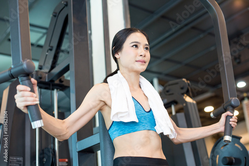 Attractive Asian woman doing exercise at gym. Woman exercise concept.