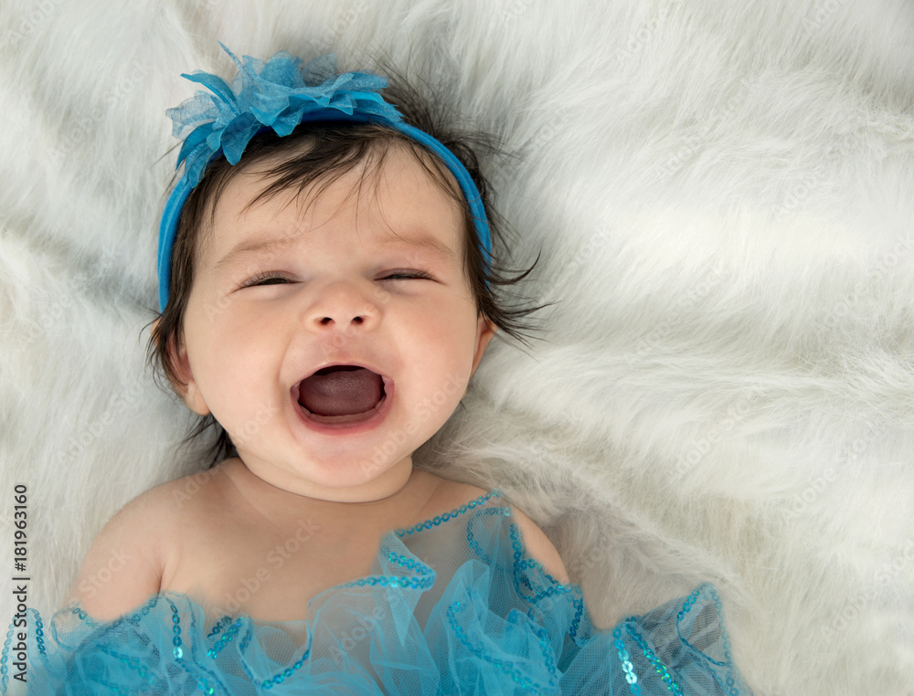 Happy, laughing two month old girl on white fur Happy, laughing two month old girl on white fur