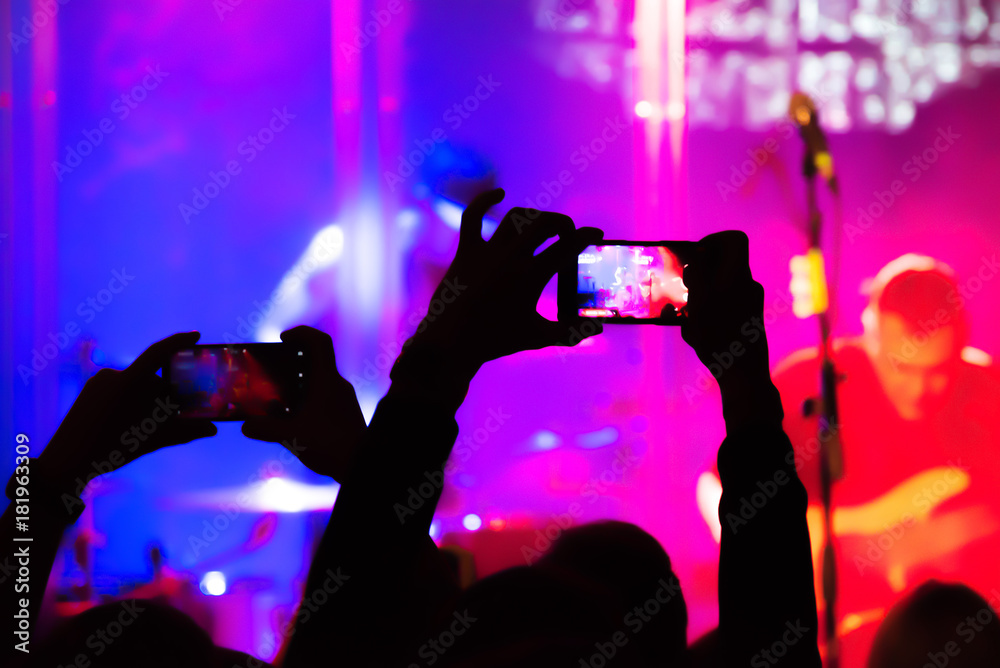 Blurred. Video recording of the concert on the smartphone phone of the Beach or club party. Conceptual background of the youth party. Blurred. Video recording of the concert on the smartphone phone of the Beach or club party. Conceptual background of the youth party.