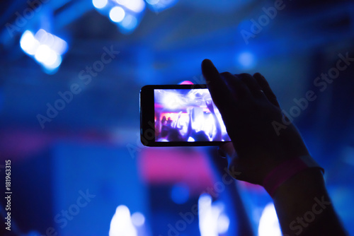 Blurred. Video recording of the concert on the smartphone phone of the Beach or club party. Conceptual background of the youth party. 
