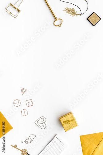 Office desk in trendy gold color. Glittering stationery on white background top view copyspace