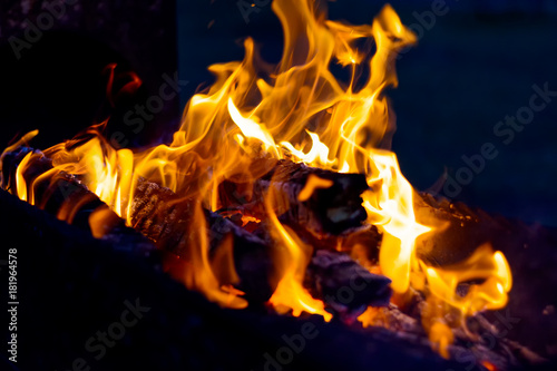 The blazing flames from the hot coals in the barbecue