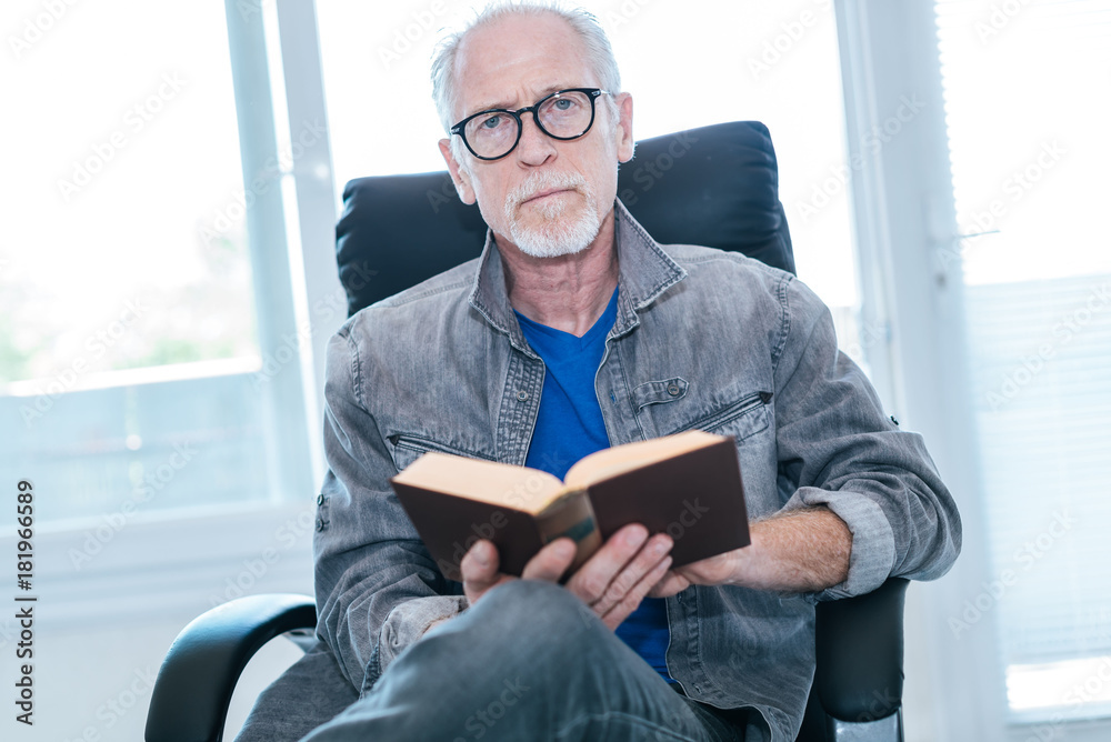 Portrait of mature man reading a book