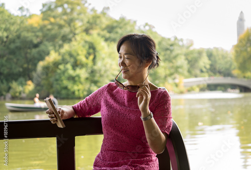 Woman reading on her phoen photo
