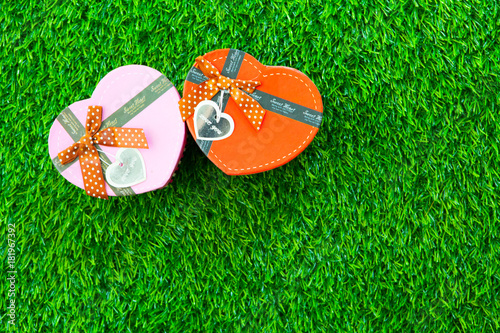 photo of beautiful gift and heart shaped box on the wonderful grass background