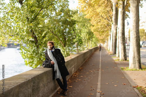 Half Nigerian man strolling near river. photo