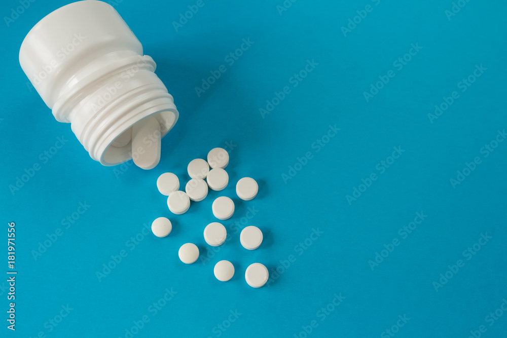 Medical medication pills and a pot on a blue background, concept of disease top view with copy space Medical medication pills and a pot on a blue background, concept of disease top view with copy space
