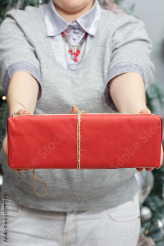 Woman hands holding the red christmas box