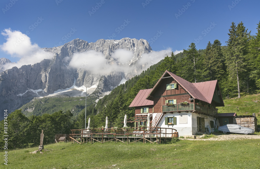 Jôf di Montasio with alpine hut in foreground, Italy