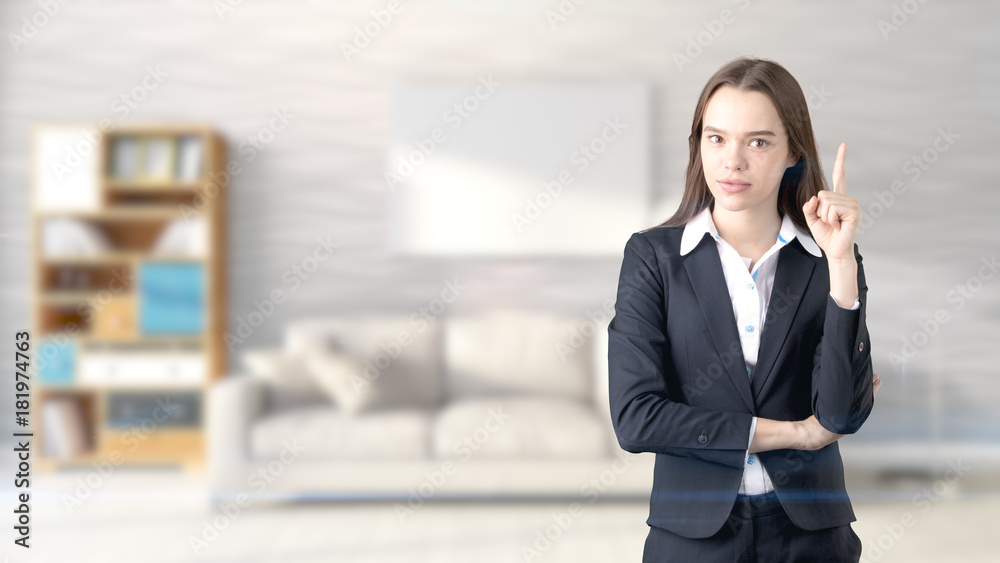 Young beautiful business woman and creative designer standing over blured interior background