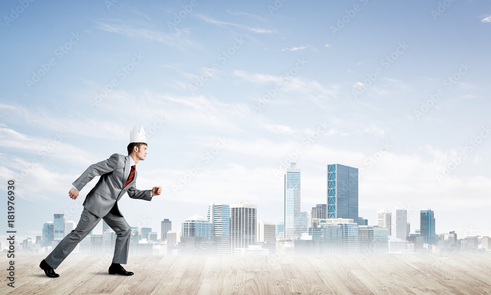 King businessman in elegant suit running and modern cityscape at background King businessman in elegant suit running and modern cityscape at background
