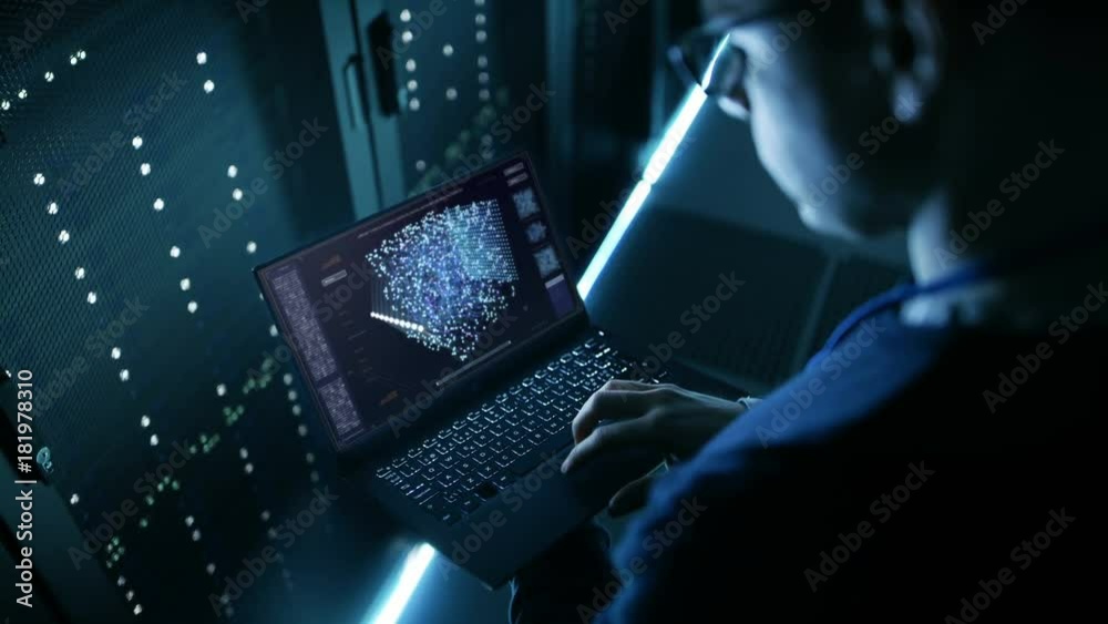 Data Center IT Engineer Holds Laptop and Works on the Neural Network AI Project.
