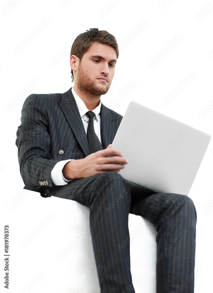 handsome young business man sitting on a white modern chair handsome young business man sitting on a white modern chair