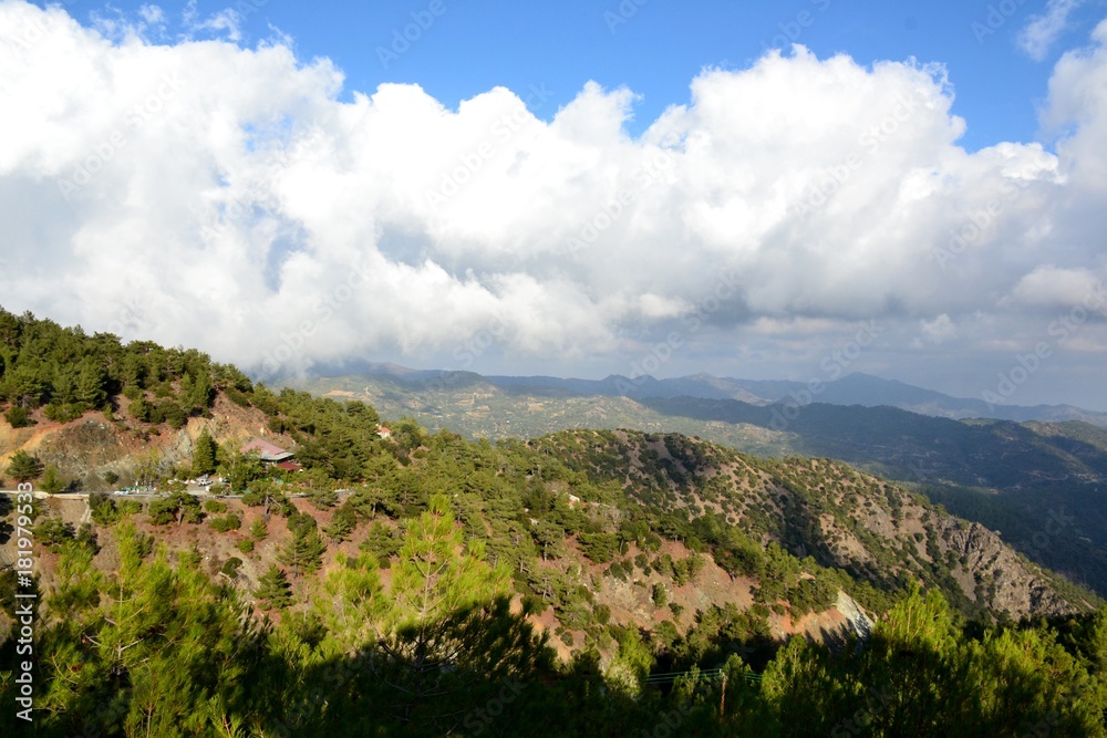 Landscape of Troodos mountains from Cyprus and cloudy blue sky