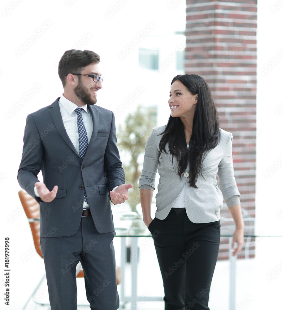employees of the company discuss working issues standing in the office employees of the company discuss working issues standing in the office