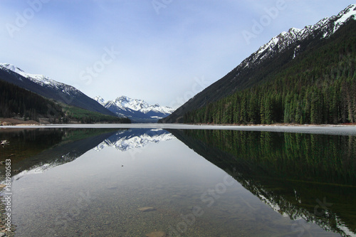 The clean mirror water of lillooet lake on the foot of mount  photo