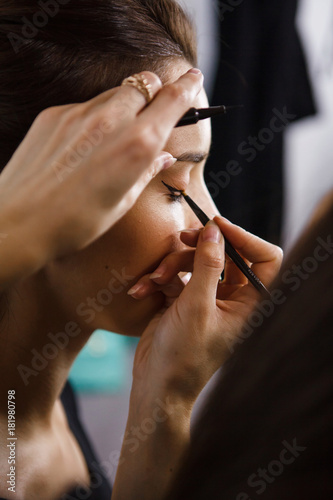 makeup artist applying eyes makeup