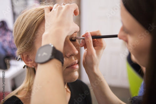makeup artist applying eyes makeup
