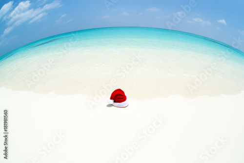 Santa Claus hat on perfect tropical bounty beach