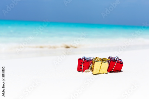Packed gifts on sand with azur sea background