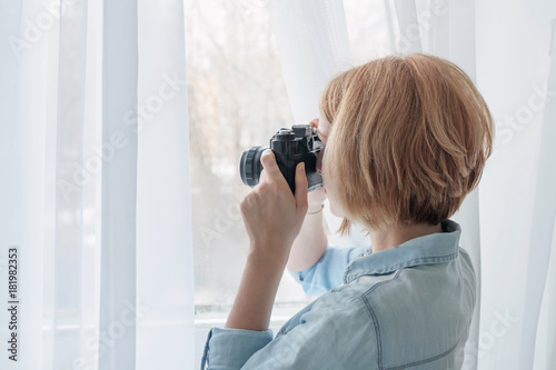 Woman taking photos through the window