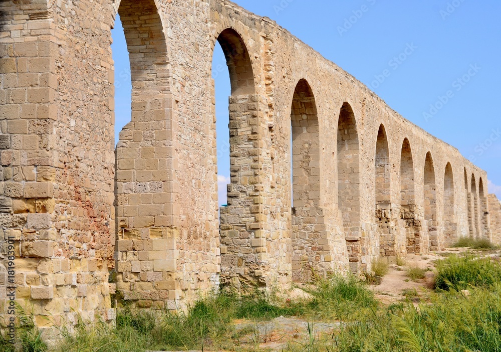 Ruins of old Kamares aqueduct from Cyprus with blue sky