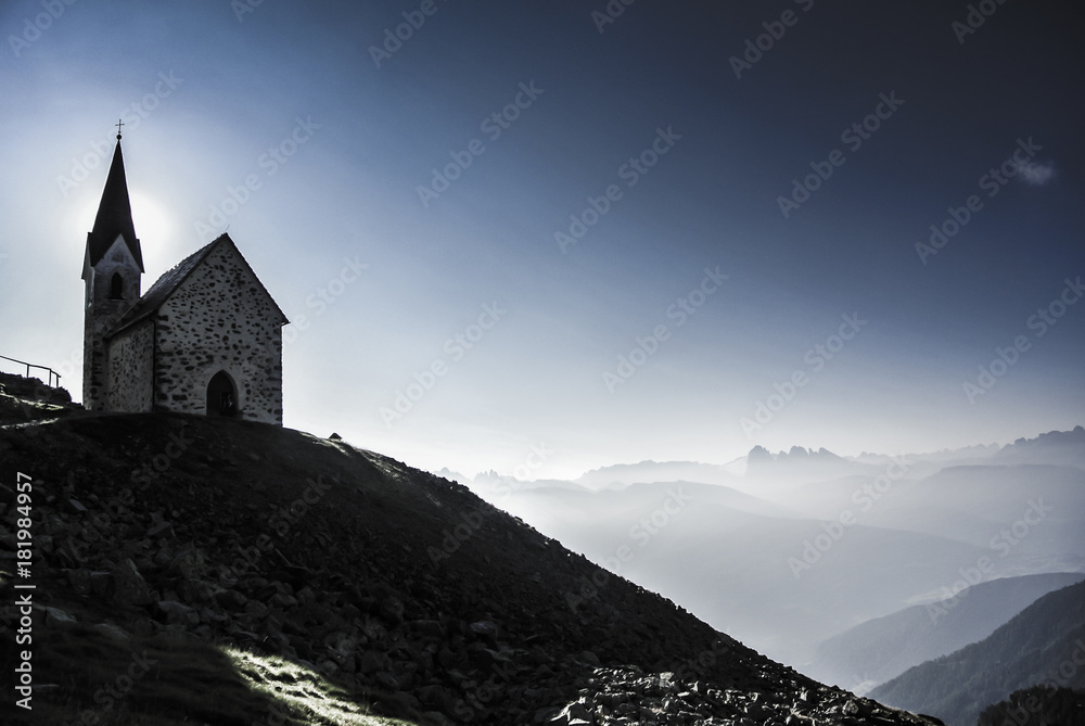 The chapel at the Latzfonser Kreuz at sunrise with a view on Dololmtes