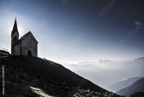 The chapel at the Latzfonser Kreuz at sunrise with a view on Dololmtes