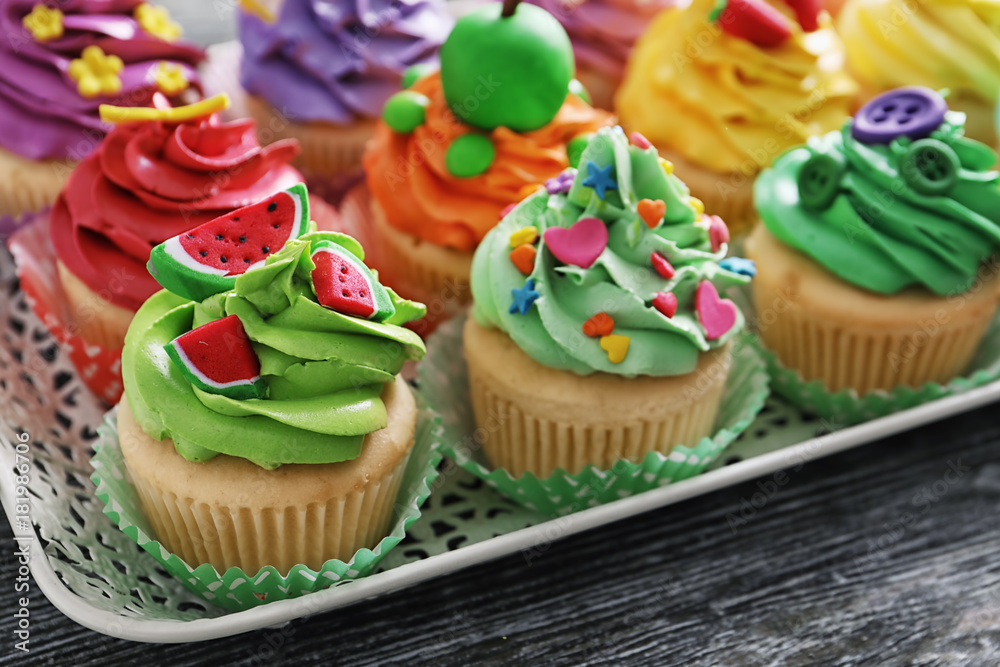 Beautiful cupcakes on vintage tray, closeup