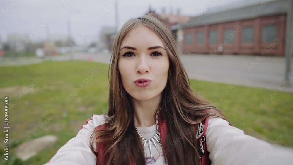 Happy hipster teen girl making selfie photo in urban background Happy hipster teen girl making selfie photo in urban background