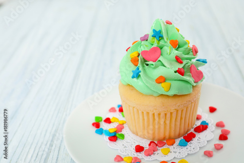 Plate with beautiful cupcake on wooden table © Africa Studio