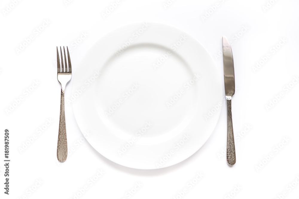 Knife, fork and plate on a white background