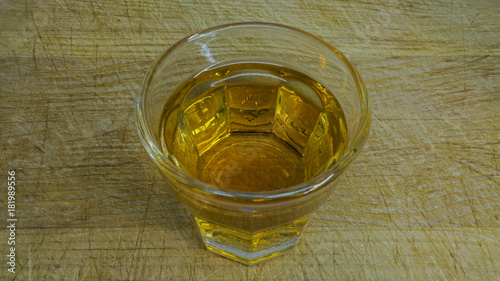 Shot Glas with schnaps on a wooden cutting board