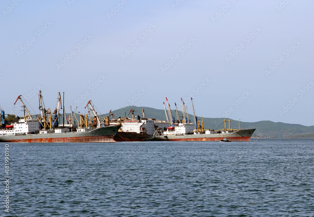 Cargo ships are in port for loading.