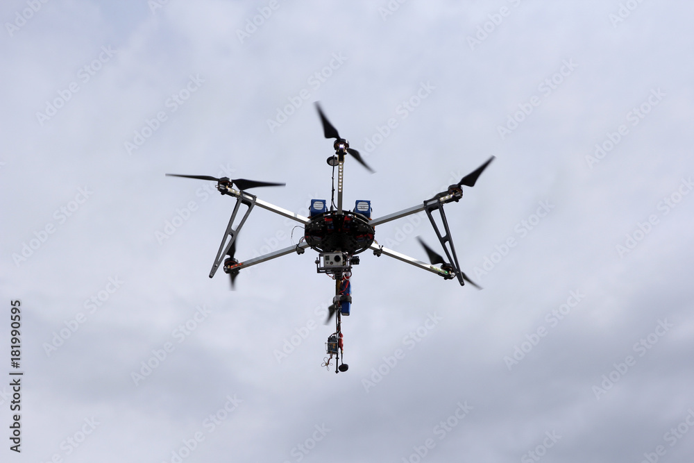 Flying drone in the sky with mounted digital camera Flying drone in the sky with mounted digital camera