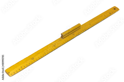 Konstfotografi Yellow wooden measuring ruler on a white background