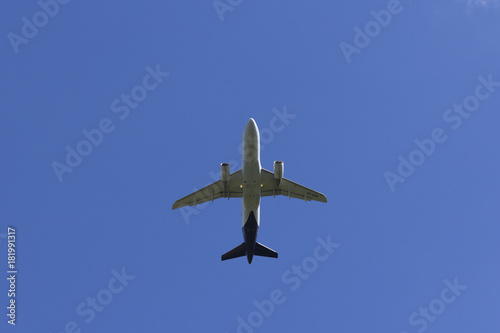 Airplane flies against a background of white cloud