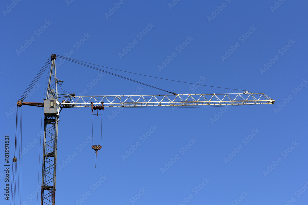 Industrial landscape, building crane against the blue sky Industrial landscape, building crane against the blue sky