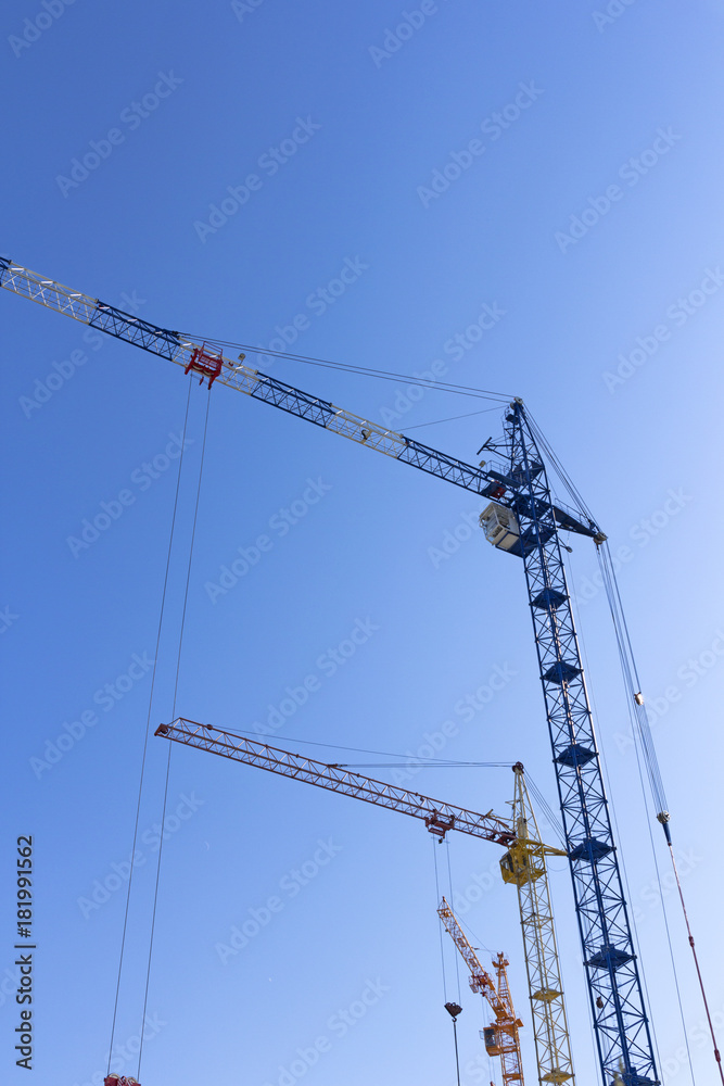 Industrial landscape, building crane against the blue sky