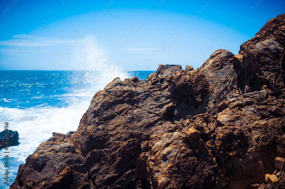 Ocean waves hitting the rocks and making a splash