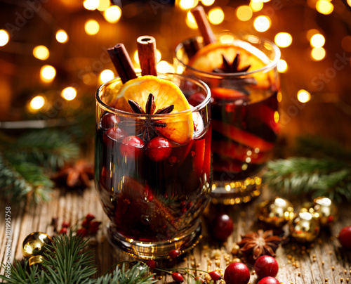 Murais de parede Christmas mulled red wine with spices and fruits on a wooden rustic table