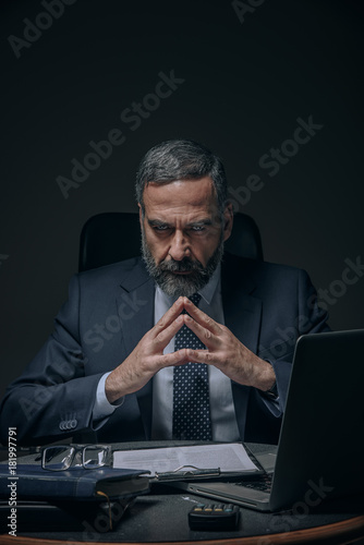 Fototapeta Senior boss, evil corporate overlord in the dark