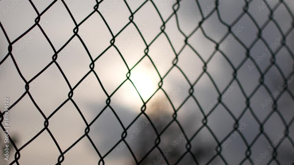 Metal net on a cloudy sky background. Last hope Metal net on a cloudy sky background. Last hope
