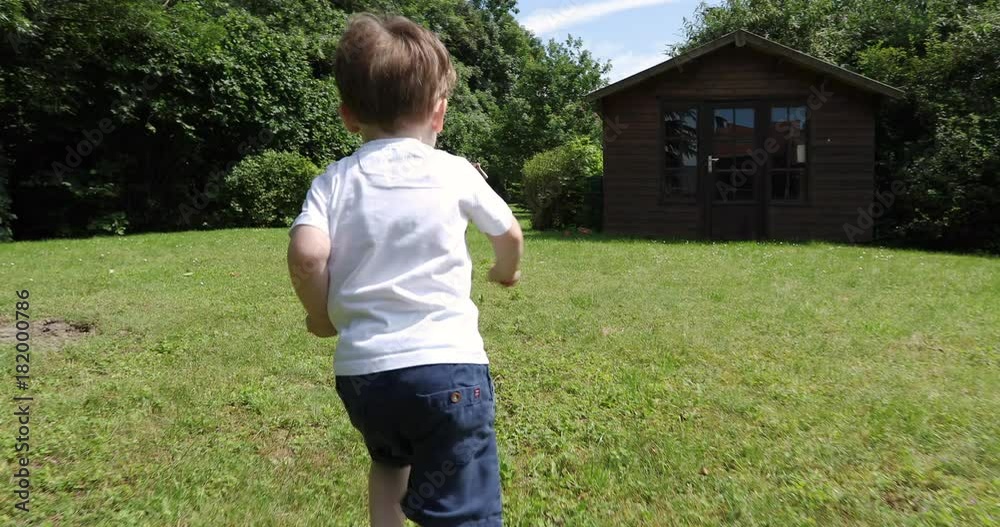 Toddler running joyful in the garden slow motion Toddler running joyful in the garden slow motion