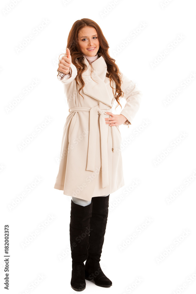 Business Woman in winter coat shows thumb up as a sign of success isolated over white background Business Woman in winter coat shows thumb up as a sign of success isolated over white background