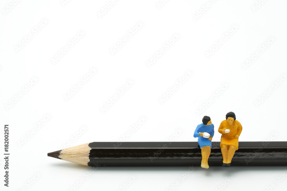 Miniature 2 people sitting on black Pencil using as background business concept with copy space. Miniature 2 people sitting on black Pencil using as background business concept with copy space.