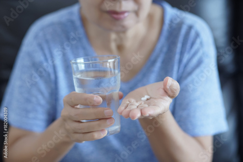 Elderly woman pill and glass of water Healthcare Medical