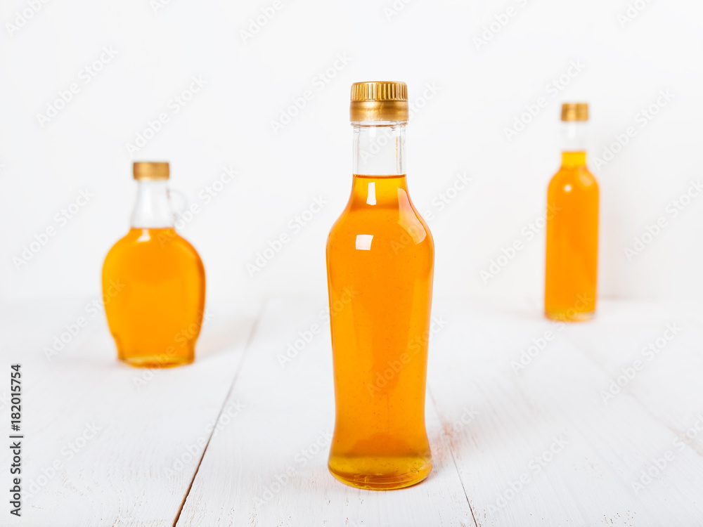Several glass bottles with homemade orange syrup Several glass bottles with homemade orange syrup