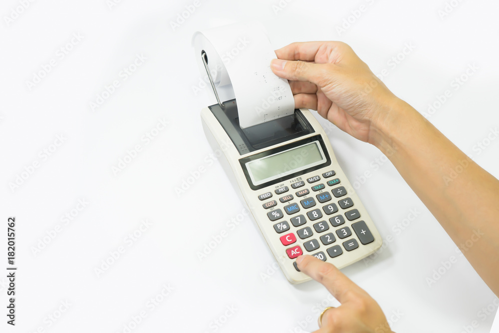 Left hand presses the keys of the printing calculator, the right hand takes out a paper check Left hand presses the keys of the printing calculator, the right hand takes out a paper check